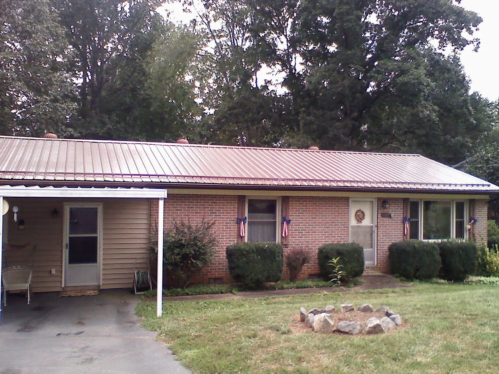 Bronze metal roof and carport on a brick ranch home — Roof Repair work by our crew in Browntown